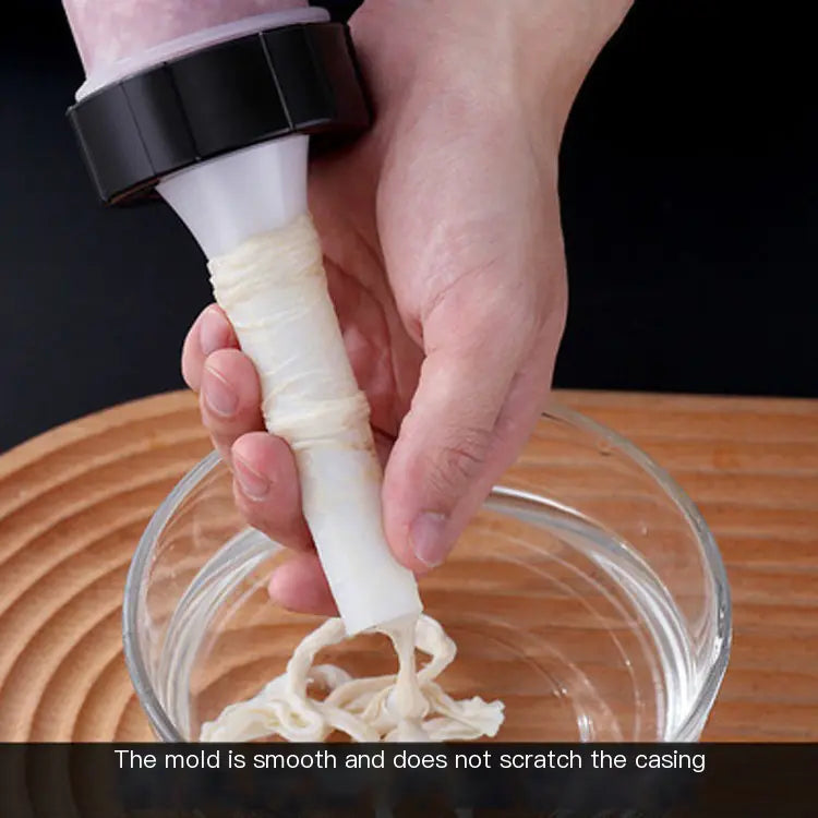 Hand using a white mold tool with black handle to extract noodles from a glass bowl on a wooden surface.
